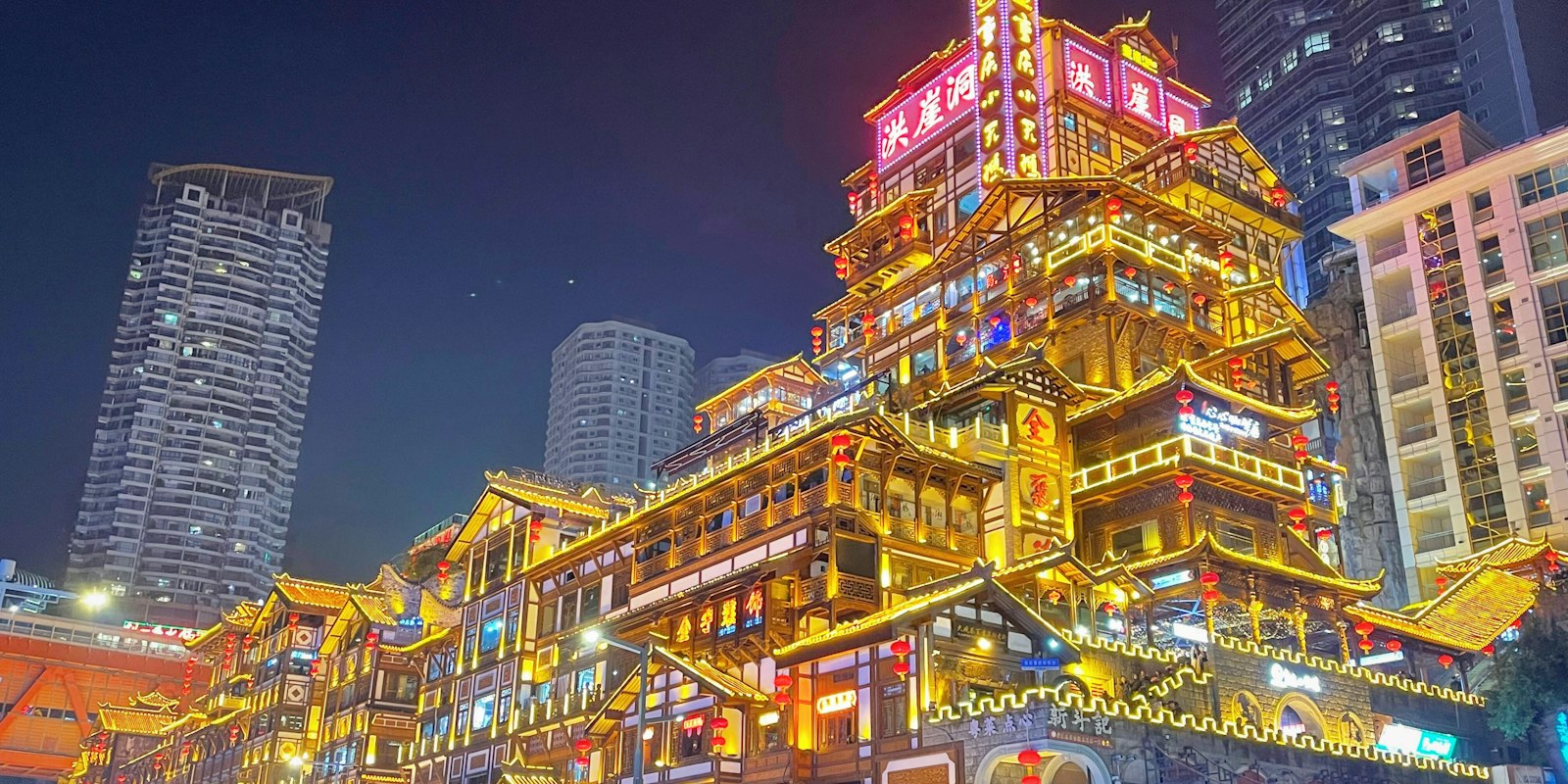 Hongyadong’s illuminated tiered buildings and traditional rooflines in Chongqing at night