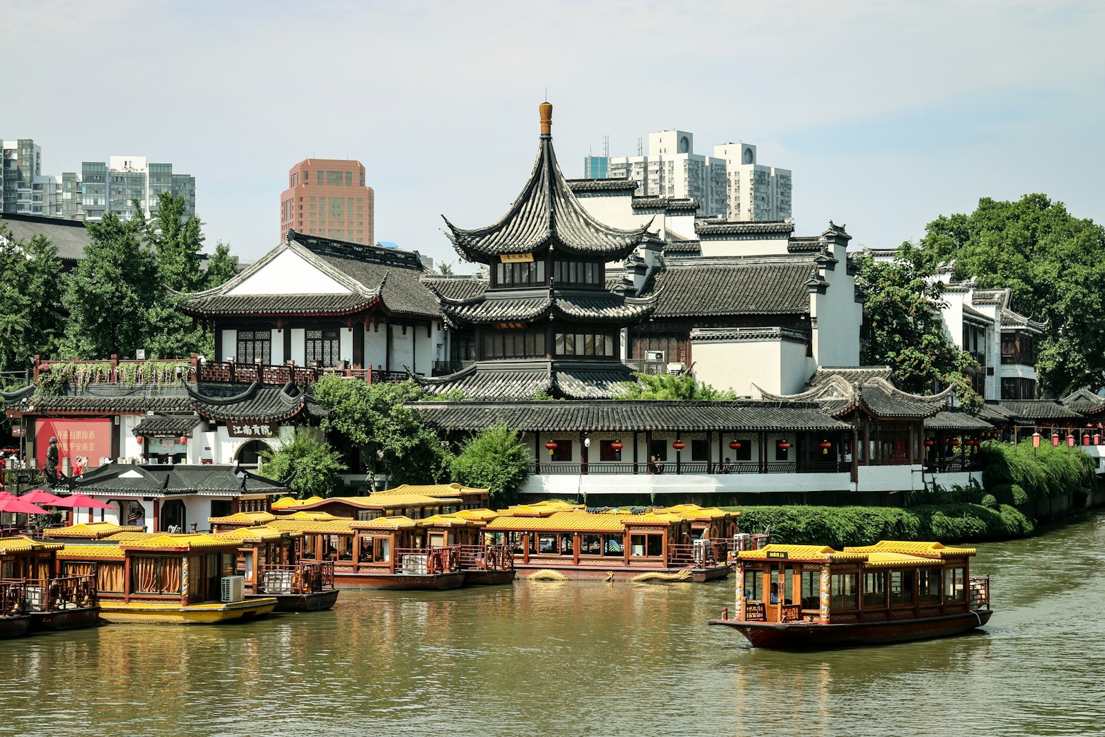 Traditional buildings and yellow-roofed boats on Nanjing’s Qinhuai River near Fuzimiao