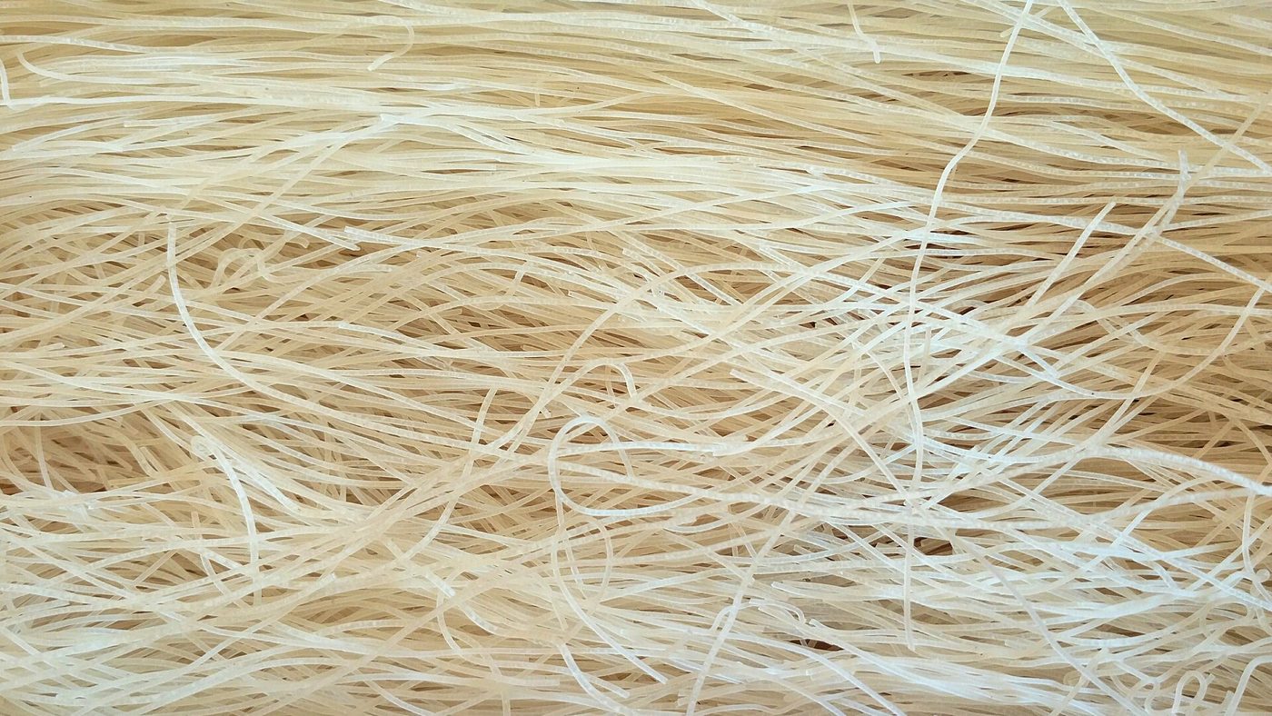 Close-up photograph of dried rice vermicelli before cooking